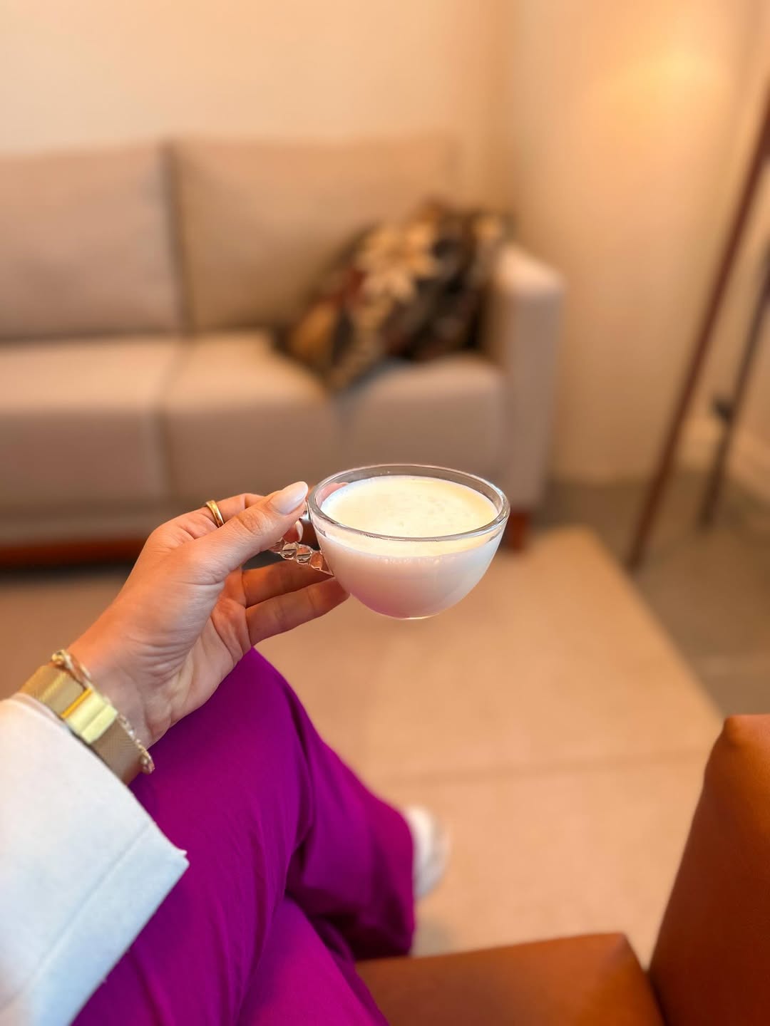 Xícara de café servida na clínica, com a mesa de madeira ao fundo.